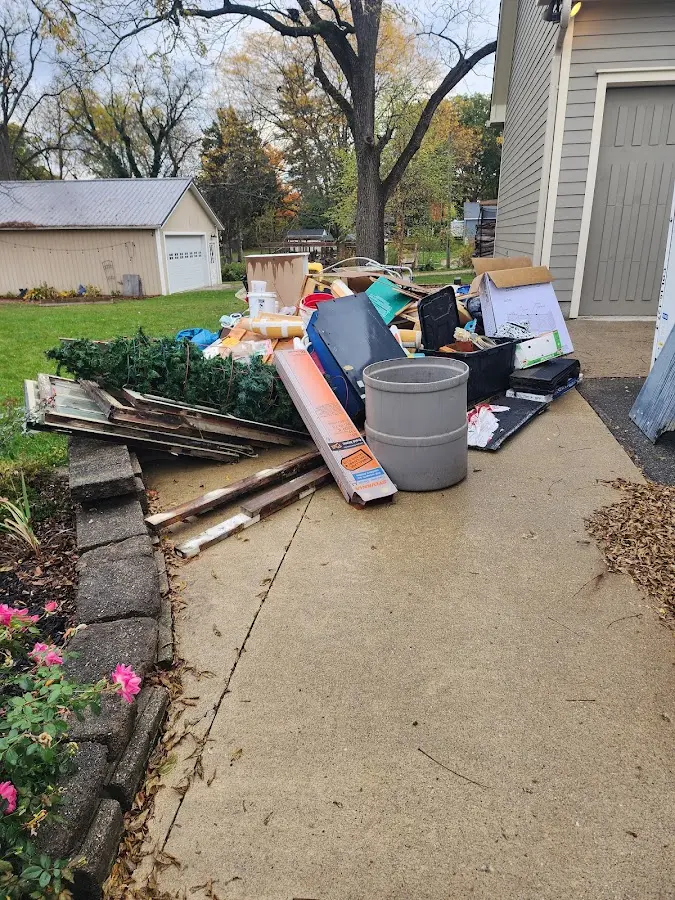 Dumpster being loaded with debris for Estate Cleanout Dumpster Rental in Pleasant Run